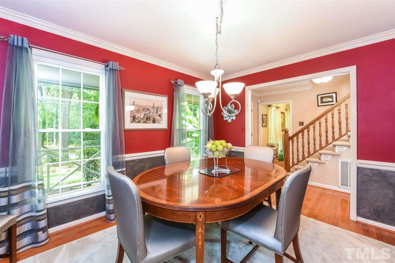 9716 Rock Creek Road Raleigh, NC 27613 - Photo 4 of 25 a dining room with furniture a chandelier and window