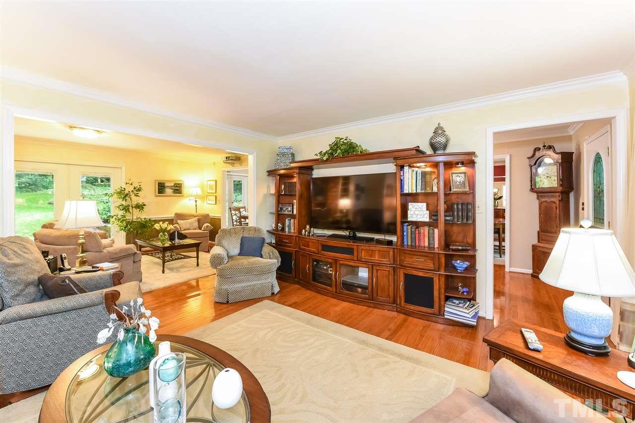 9716 Rock Creek Road Raleigh, NC 27613 - Photo 5 of 25 a living room with furniture and a flat screen tv