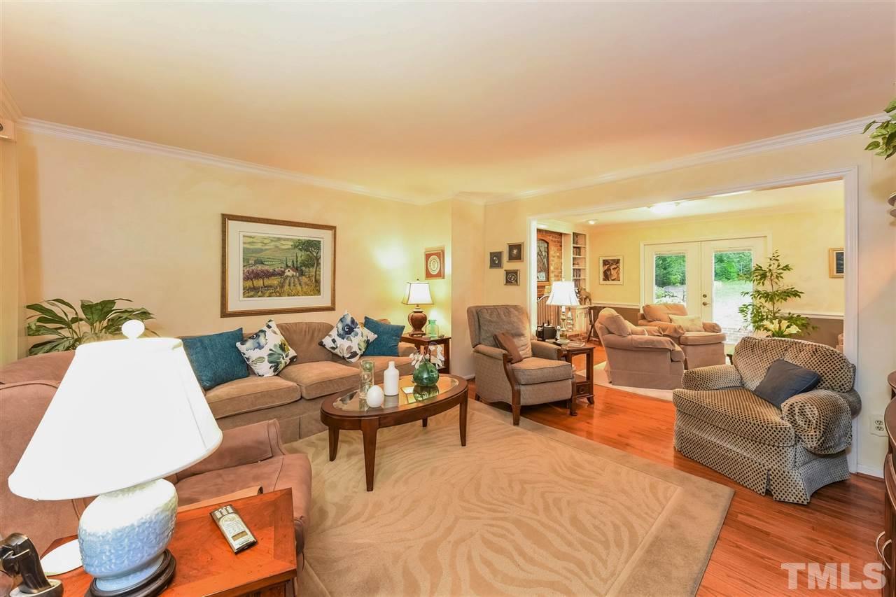 9716 Rock Creek Road Raleigh, NC 27613 - Photo 6 of 25 a living room with furniture and a lamp