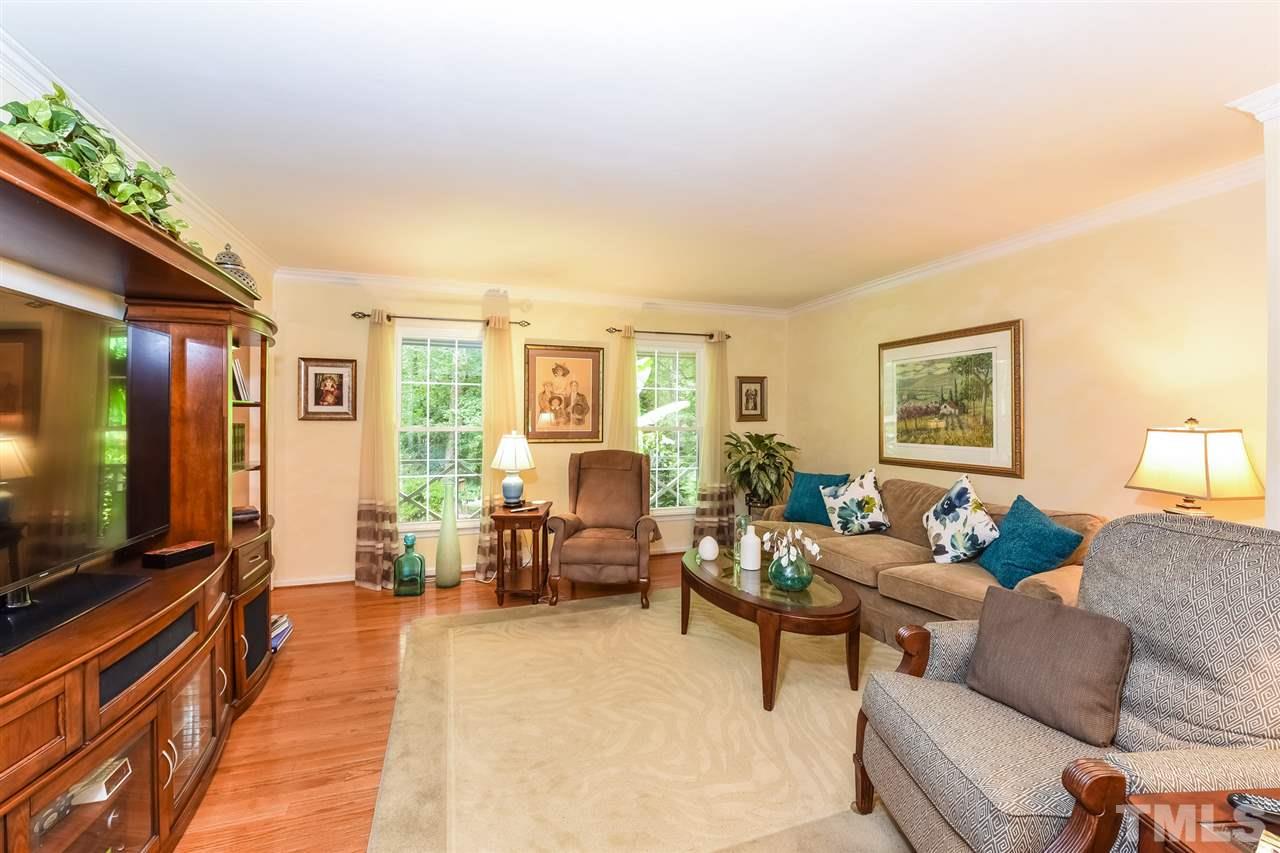 9716 Rock Creek Road Raleigh, NC 27613 - Photo 7 of 25 a living room with furniture and a flat screen tv