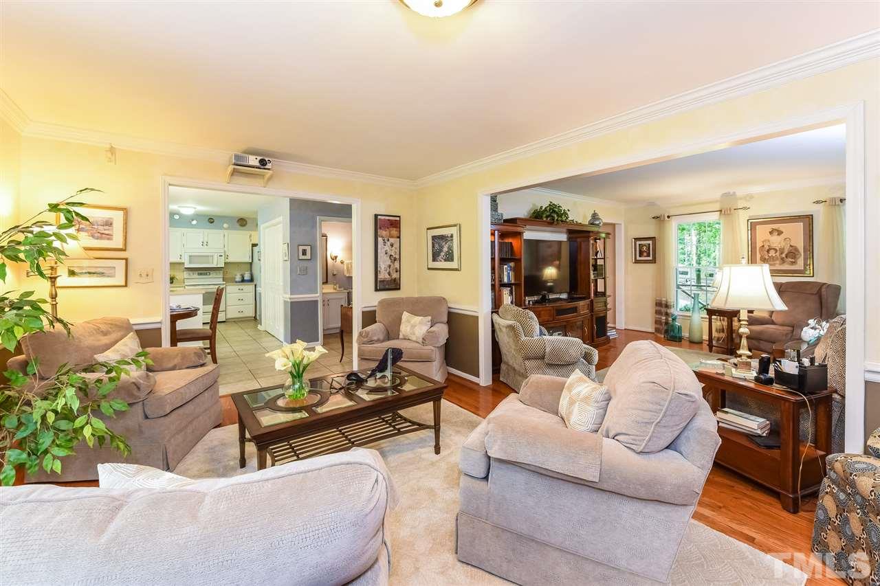 9716 Rock Creek Road Raleigh, NC 27613 - Photo 8 of 25 a living room with furniture and a flat screen tv
