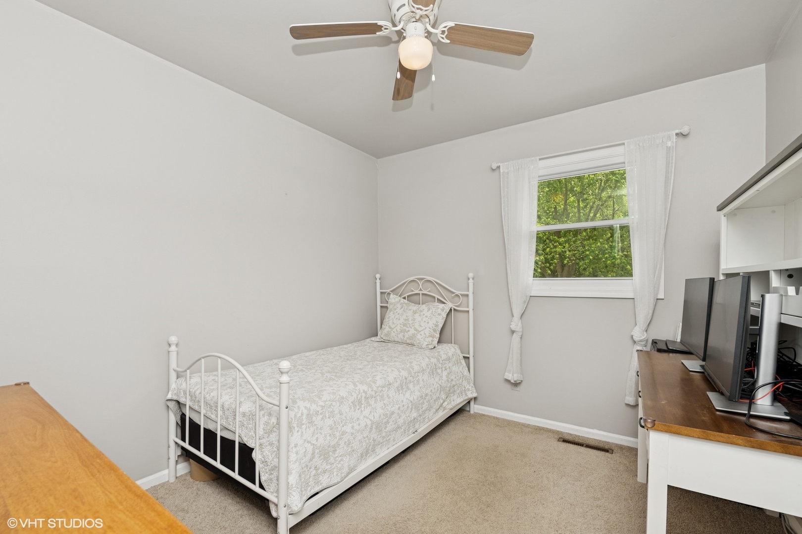 505 Crest Drive Cary, IL 60013 - Photo 10 of 18 a bedroom with a bed and a flat tv screen on the dresser
