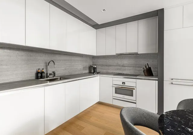 a kitchen with a sink cabinets and a window