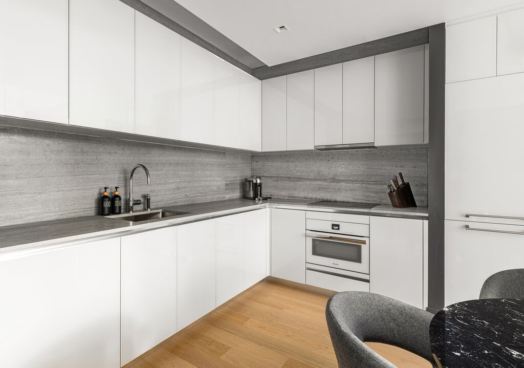 1 Wall Street, Unit 710 Manhattan, NY 10005 - Photo 2 of 19 a kitchen with a sink cabinets and a window