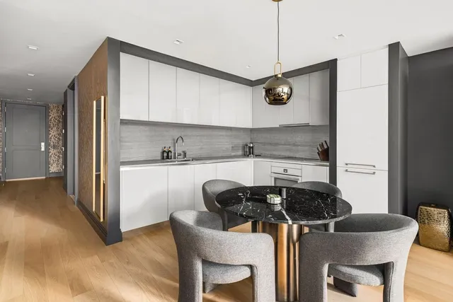 a kitchen with a table chairs and a refrigerator