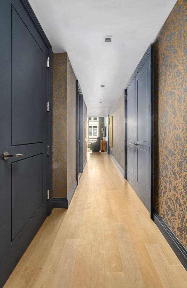 1 Wall Street, Unit 710 Manhattan, NY 10005 - Photo 5 of 19 a view of a hallway with wooden floor