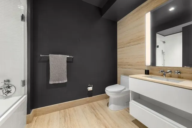 a bathroom with a sink toilet and mirror