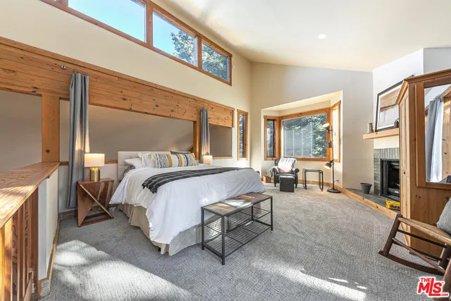 a spacious bedroom with a bed a couch and dresser