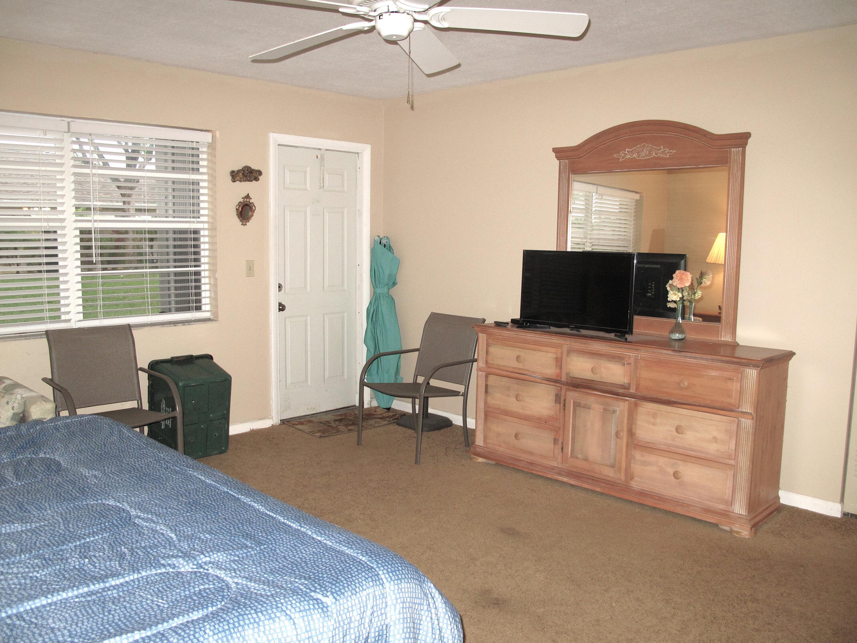 1315 High Point Way Southeast, Unit B Delray Beach, FL 33445 - Photo 18 of 41 a bedroom with a bed and a television