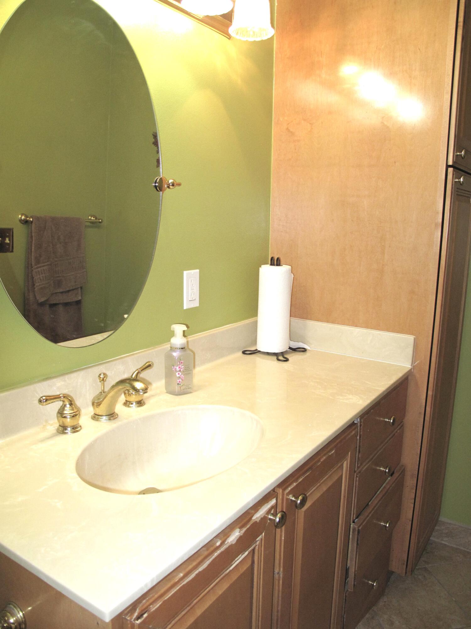 1315 High Point Way Southeast, Unit B Delray Beach, FL 33445 - Photo 19 of 41 a bathroom with a sink and a mirror