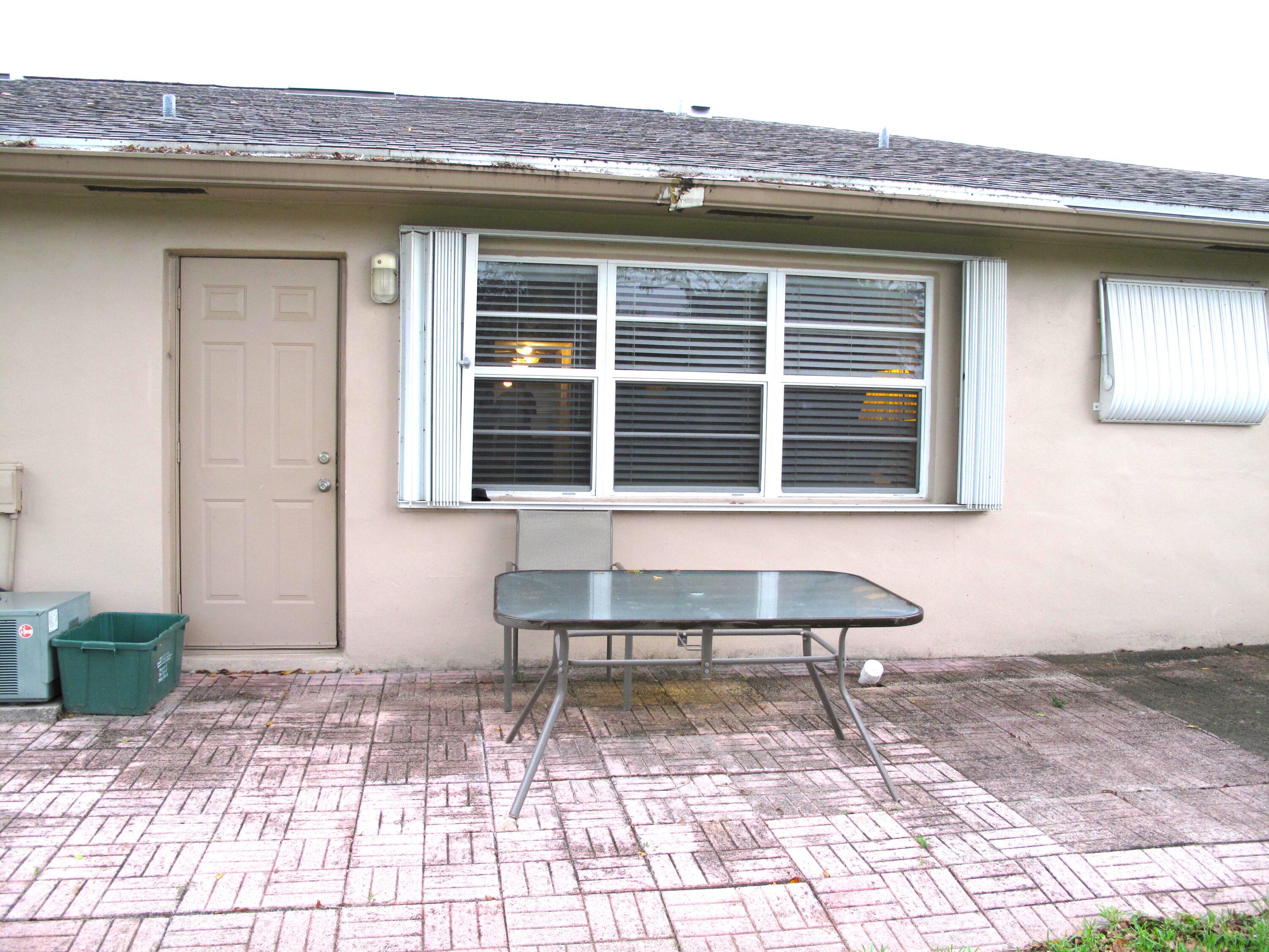 1315 High Point Way Southeast, Unit B Delray Beach, FL 33445 - Photo 23 of 41 a view of a brick house with many windows