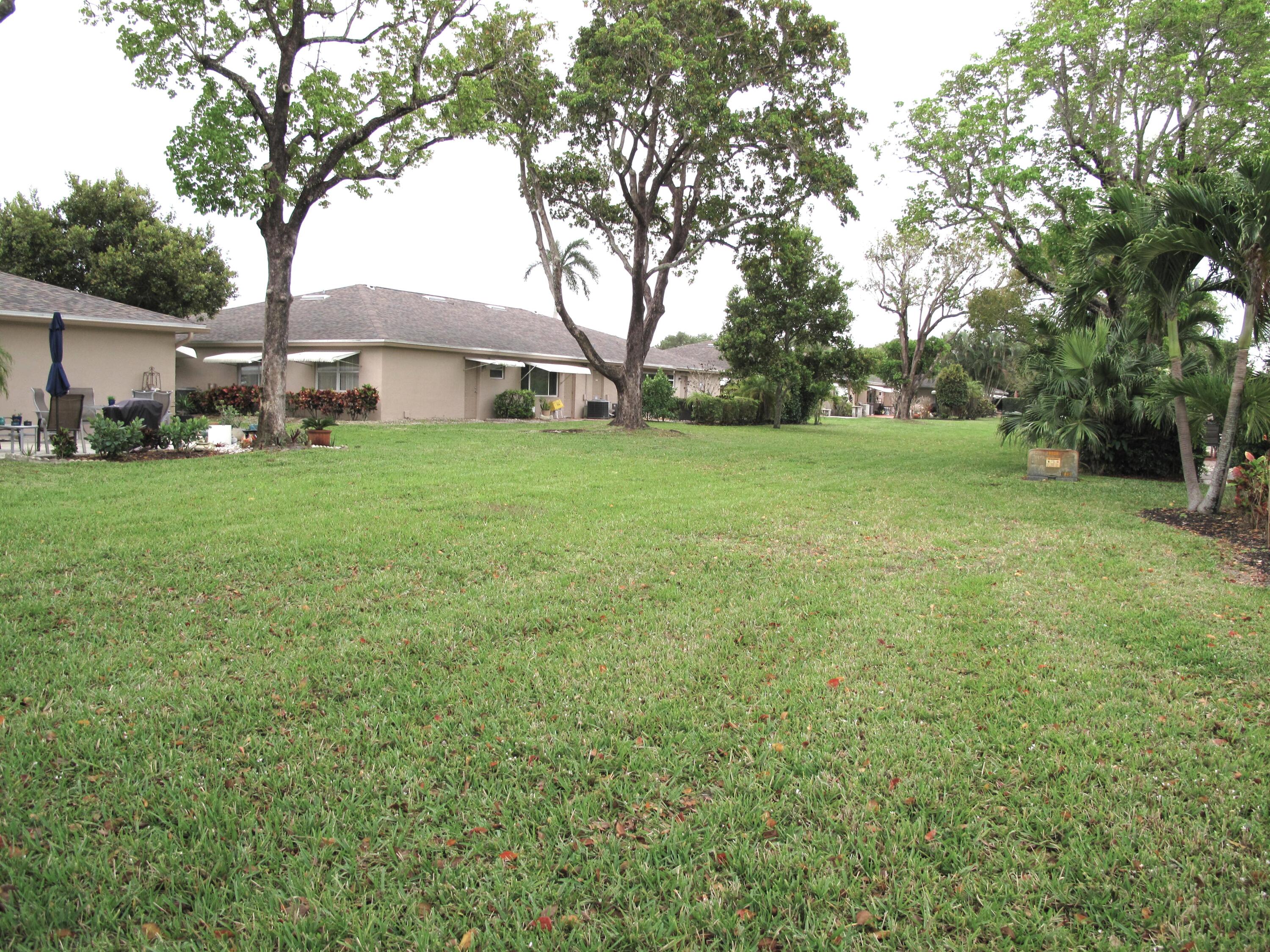 1315 High Point Way Southeast, Unit B Delray Beach, FL 33445 - Photo 24 of 41 a yellow house in middle of the forest