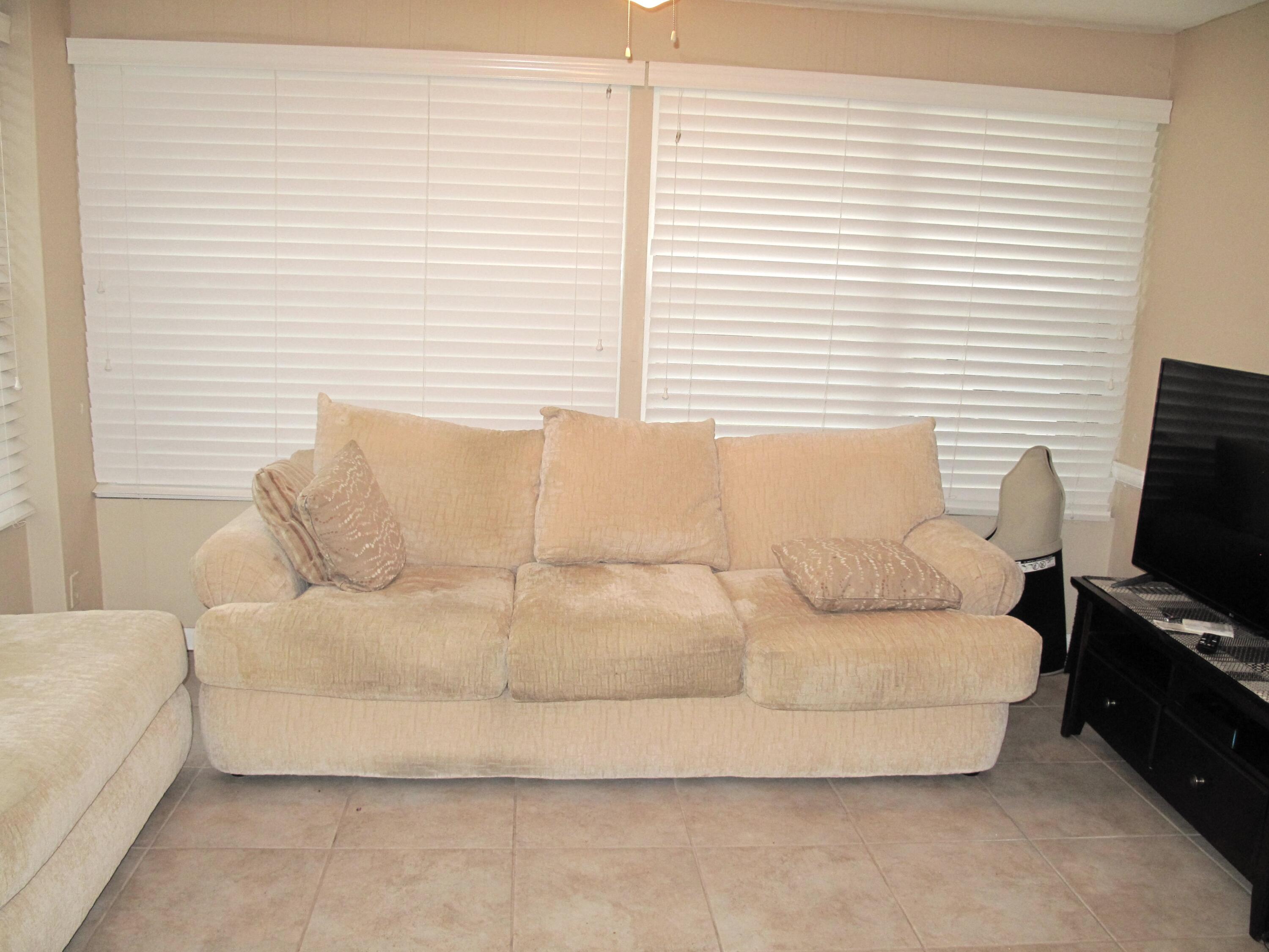 1315 High Point Way Southeast, Unit B Delray Beach, FL 33445 - Photo 3 of 41 a living room with a couch and a flat screen tv