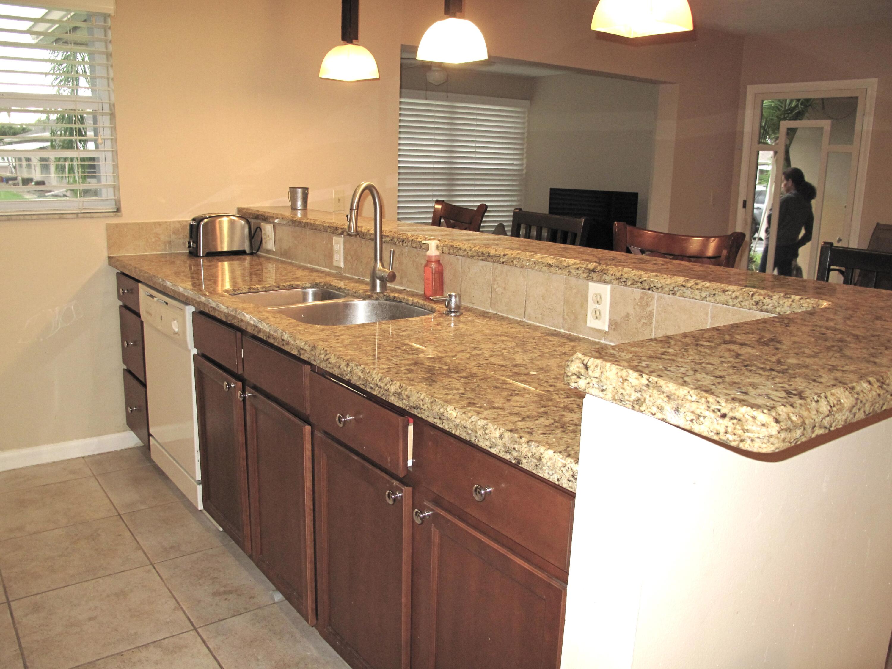 1315 High Point Way Southeast, Unit B Delray Beach, FL 33445 - Photo 7 of 41 a bathroom with a granite countertop sink and a mirror