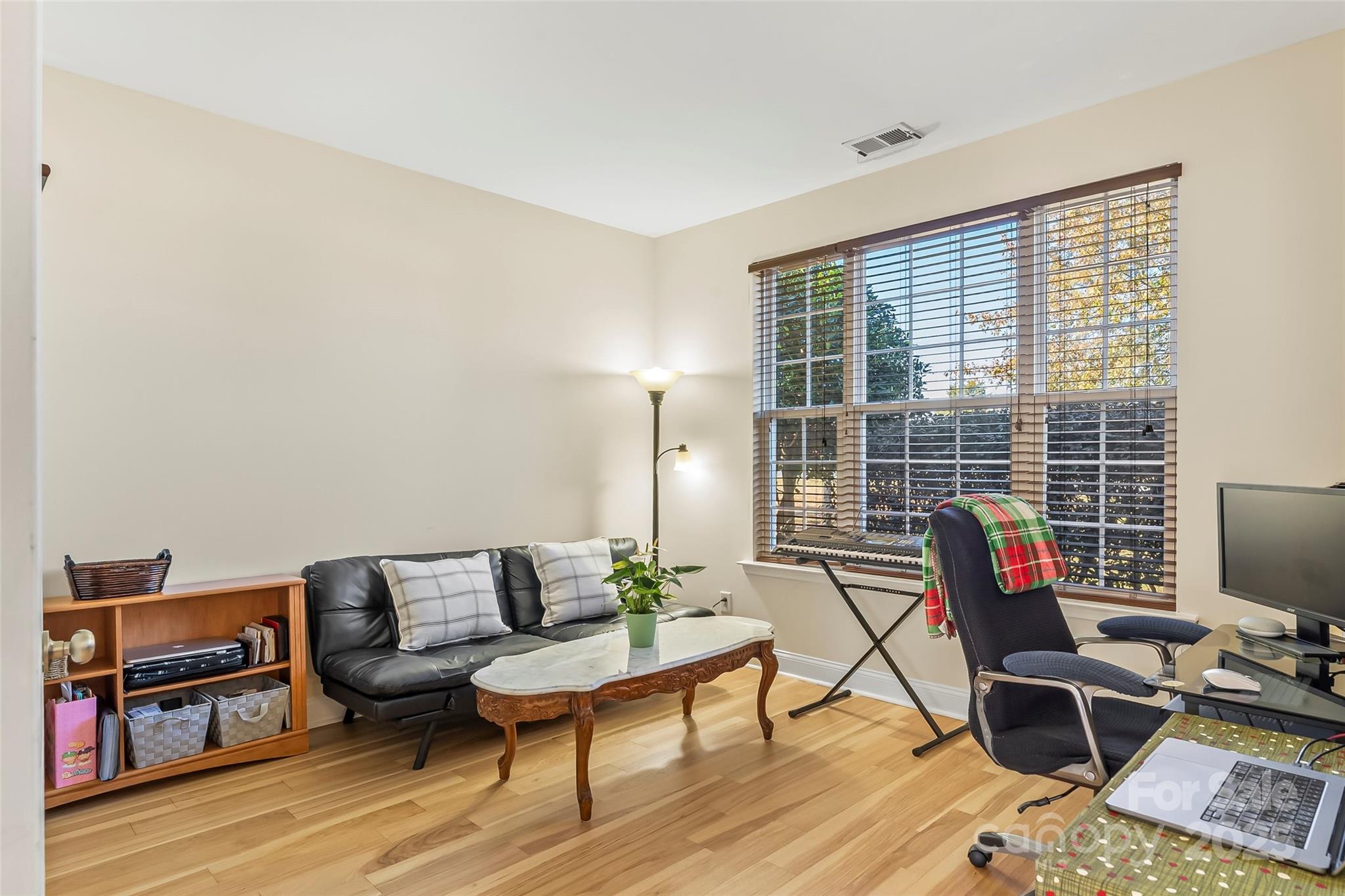1450 Jc Raulston Court Hickory, NC 28602 - Photo 14 of 35 a living room with furniture a rug and a flat screen tv