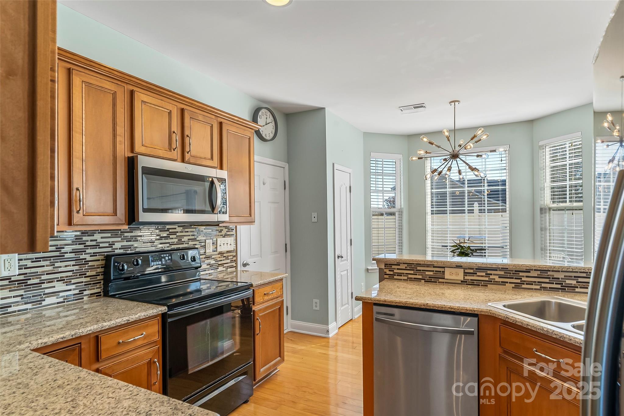 1450 Jc Raulston Court Hickory, NC 28602 - Photo 5 of 35 a kitchen with stainless steel appliances granite countertop a stove and a sink