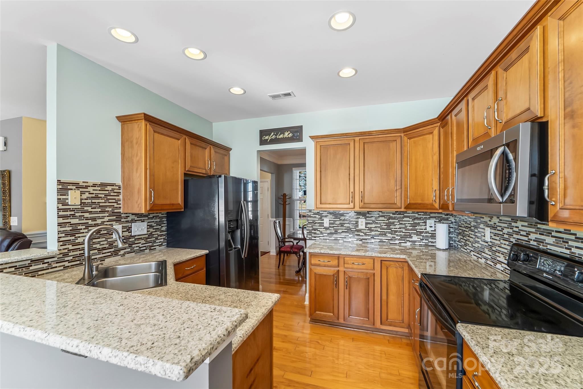 1450 Jc Raulston Court Hickory, NC 28602 - Photo 10 of 35 a kitchen with stainless steel appliances granite countertop a sink stove and refrigerator