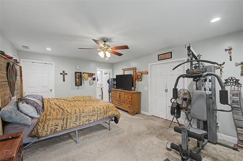 483 Coal Road Northwest Resaca, GA 30735 - Photo 27 of 56 a bedroom with a bed and a walk in closet