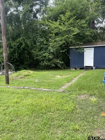 a view of a backyard with large trees