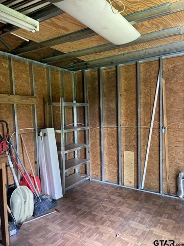 a view of a room with wooden floor and windows