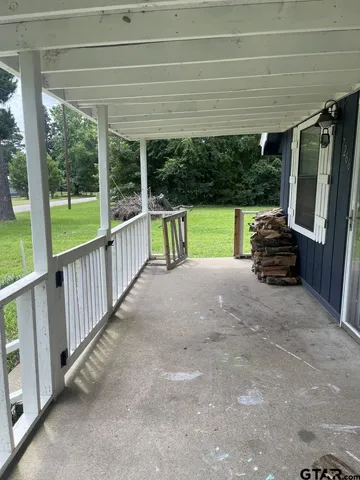a view of porch with furniture and garden