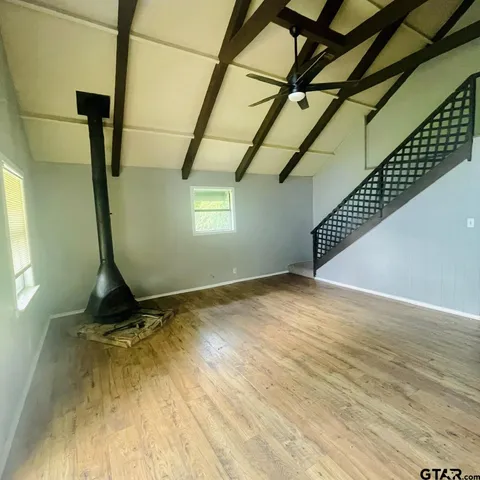 a view of a room with wooden floor and windows