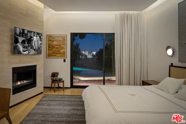 a bedroom with a bed and a fireplace