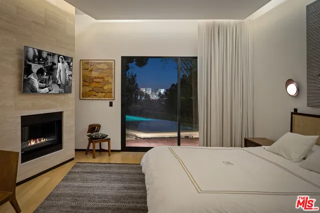 a bedroom with a bed and a fireplace