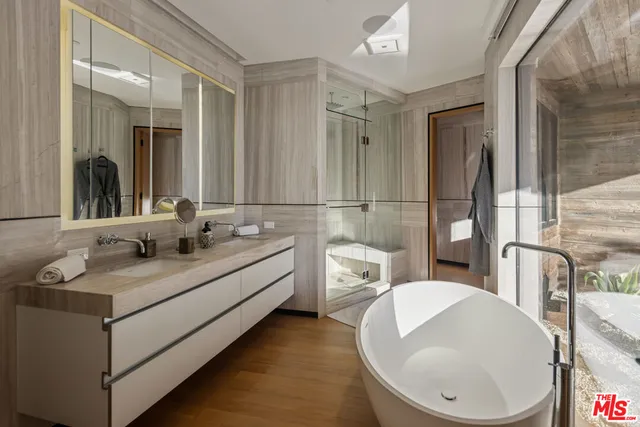 a bathroom with a sink mirror and a shower