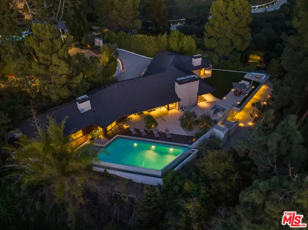 an aerial view of a house with a yard basket ball court and outdoor seating