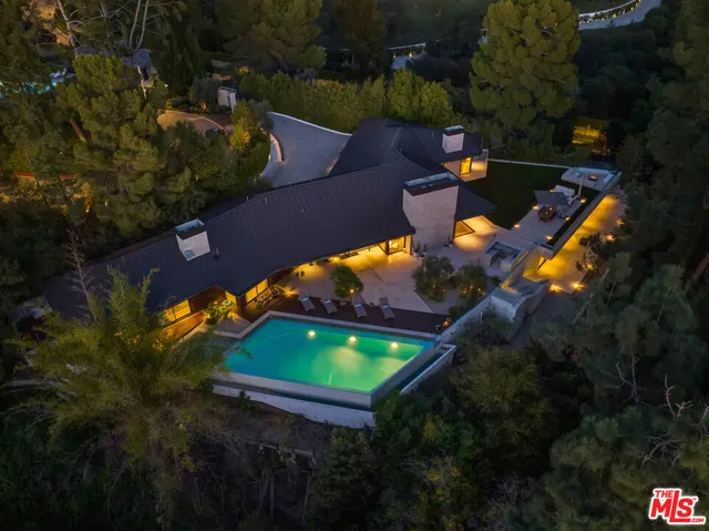 an aerial view of a house with a yard basket ball court and outdoor seating