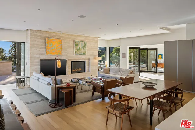 a work room with furniture wooden floor and windows