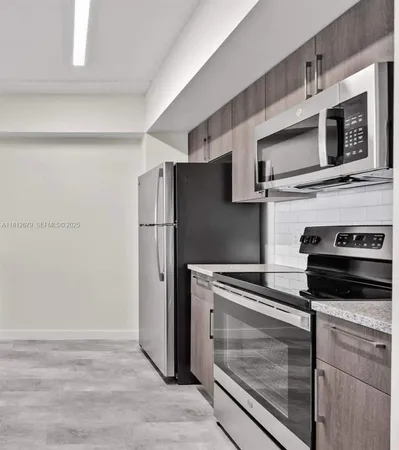 a kitchen with stainless steel appliances and cabinets