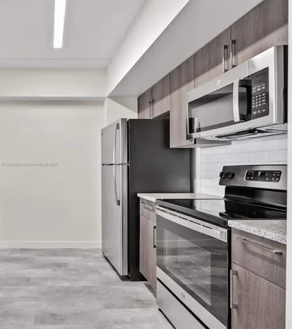 a kitchen with stainless steel appliances and cabinets