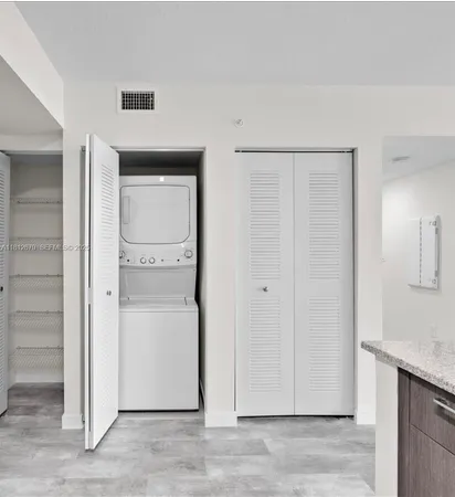 a view of a livingroom with wooden floor and a hallway