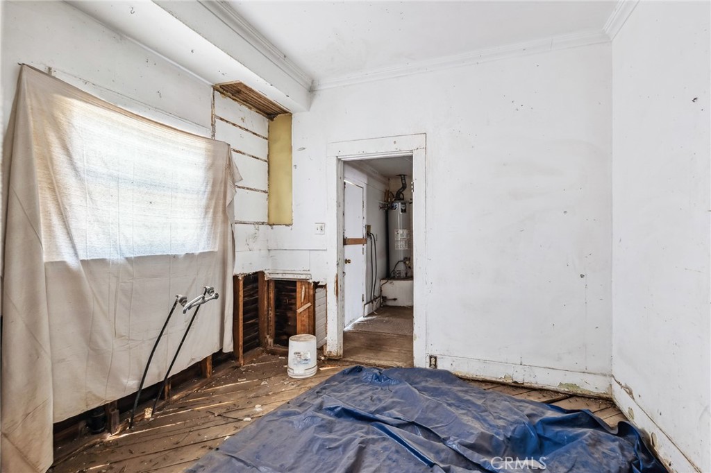 518 A Street Needles, CA 92363 - Photo 12 of 49 a view of an empty room with wooden floor and a window