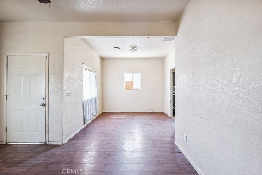 518 A Street Needles, CA 92363 - Photo 27 of 49 an empty room with wooden floor and mirror