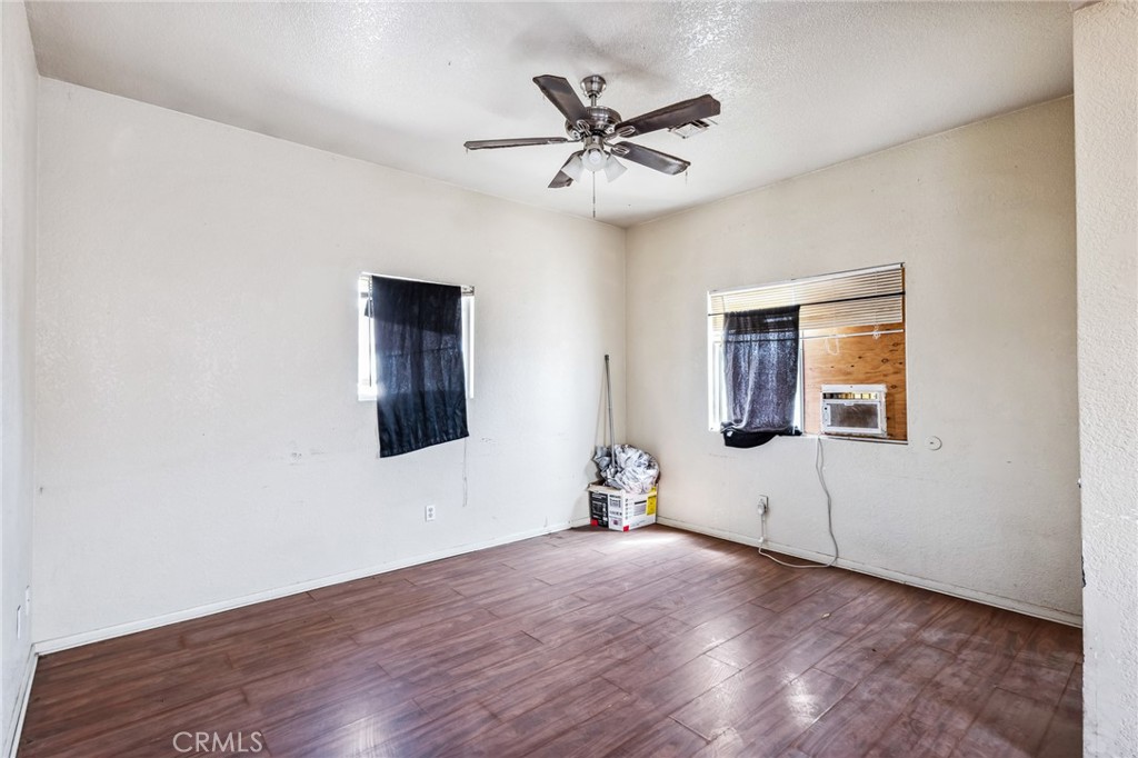 518 A Street Needles, CA 92363 - Photo 28 of 49 a view of a livingroom with wooden floor and a ceiling fan