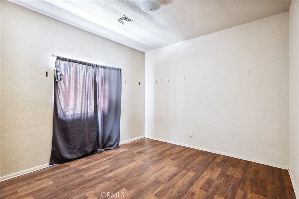 518 A Street Needles, CA 92363 - Photo 33 of 49 an empty room with wooden floor