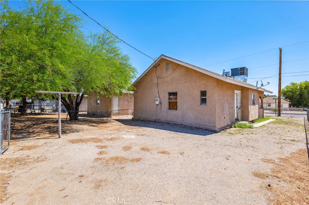 518 A Street Needles, CA 92363 - Photo 8 of 49 a view of a house with backyard and trees