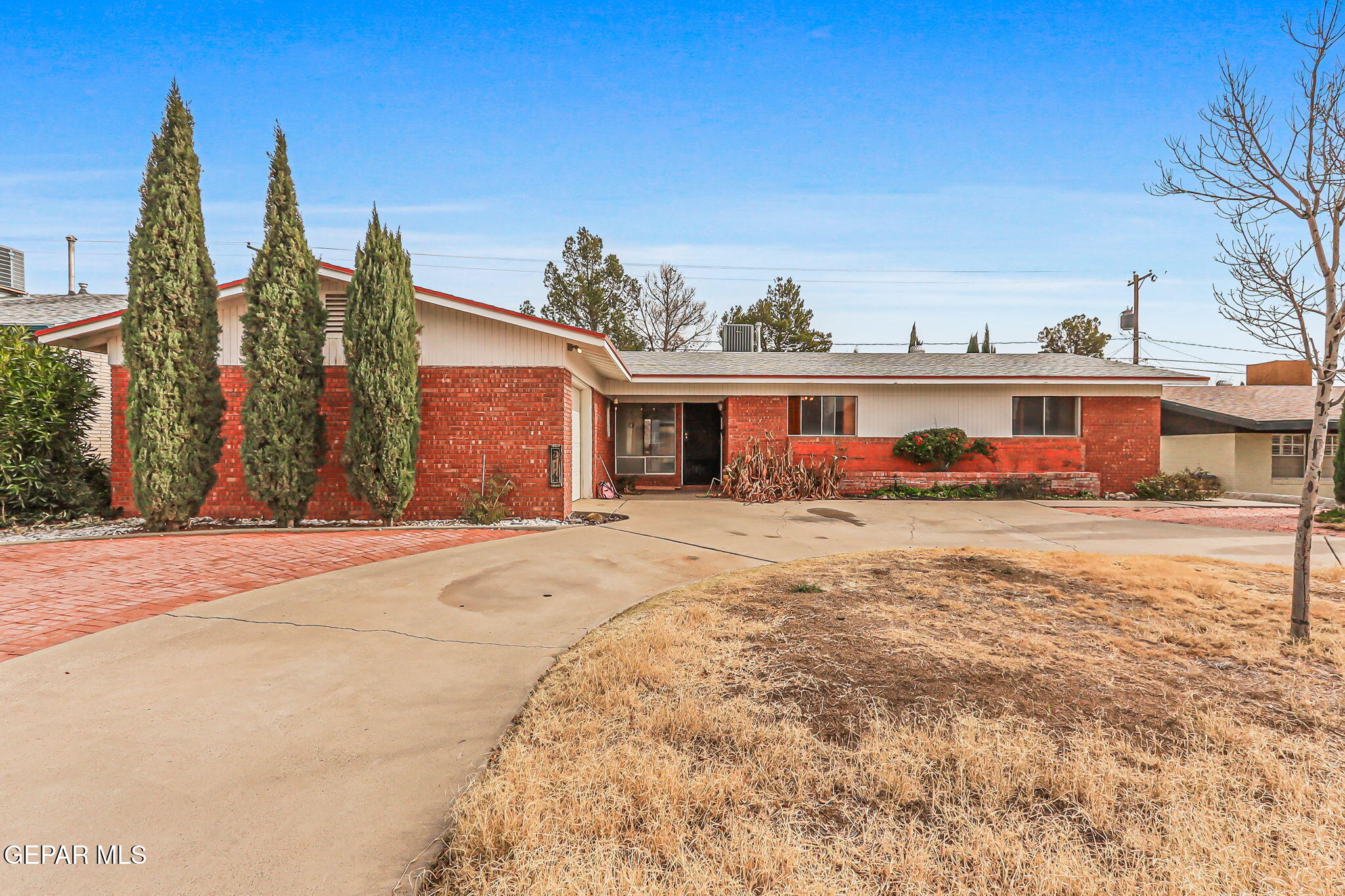 a front view of a house with a yard and a garage