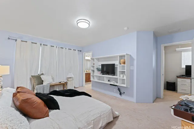 a bedroom with a bed and a lamp on the dresser