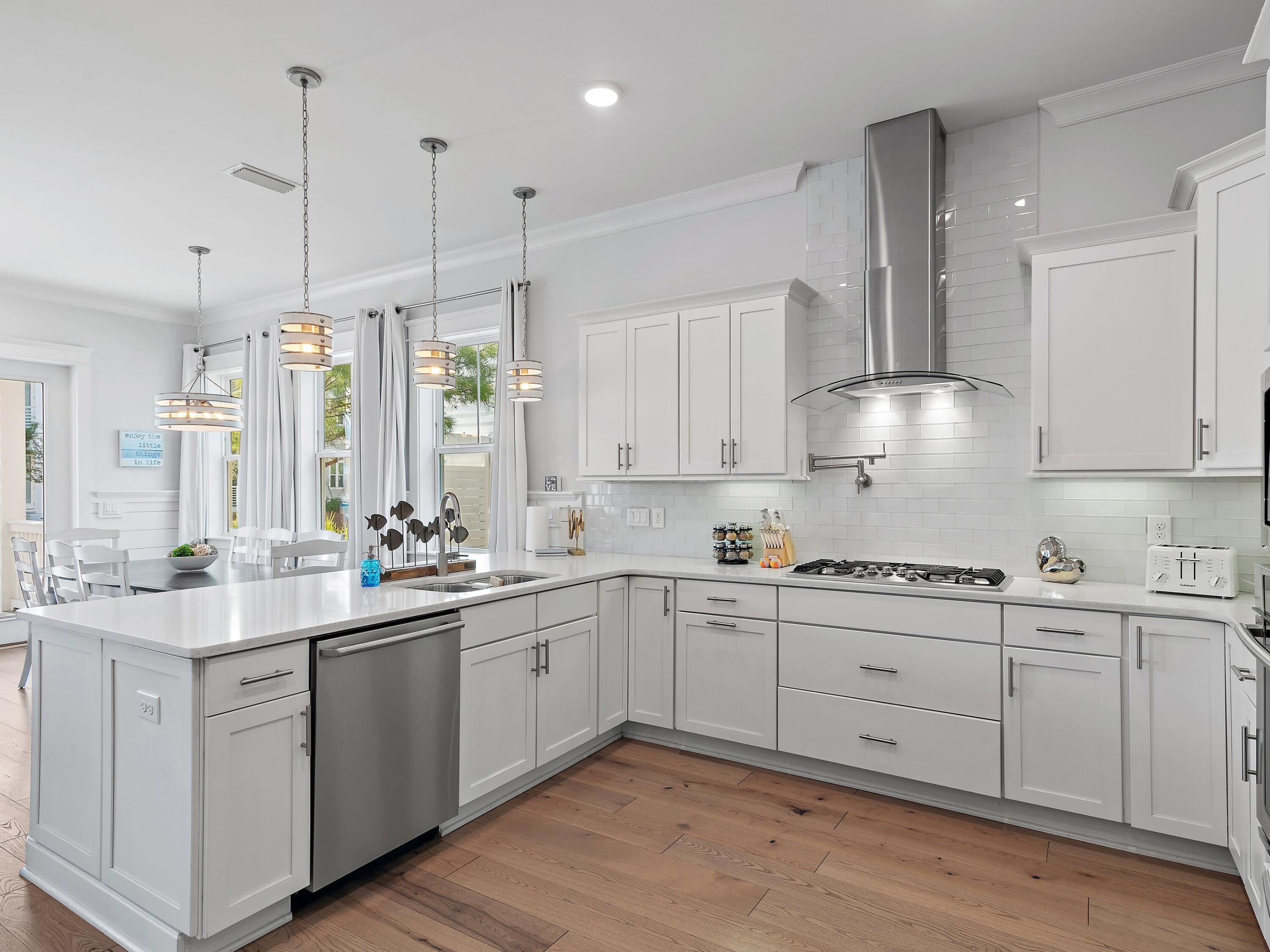 93 East Crabbing Hole Ln Inlet Beach Inlet Beach, FL 32461 - Photo 13 of 49 a kitchen with white cabinets sink and white appliances