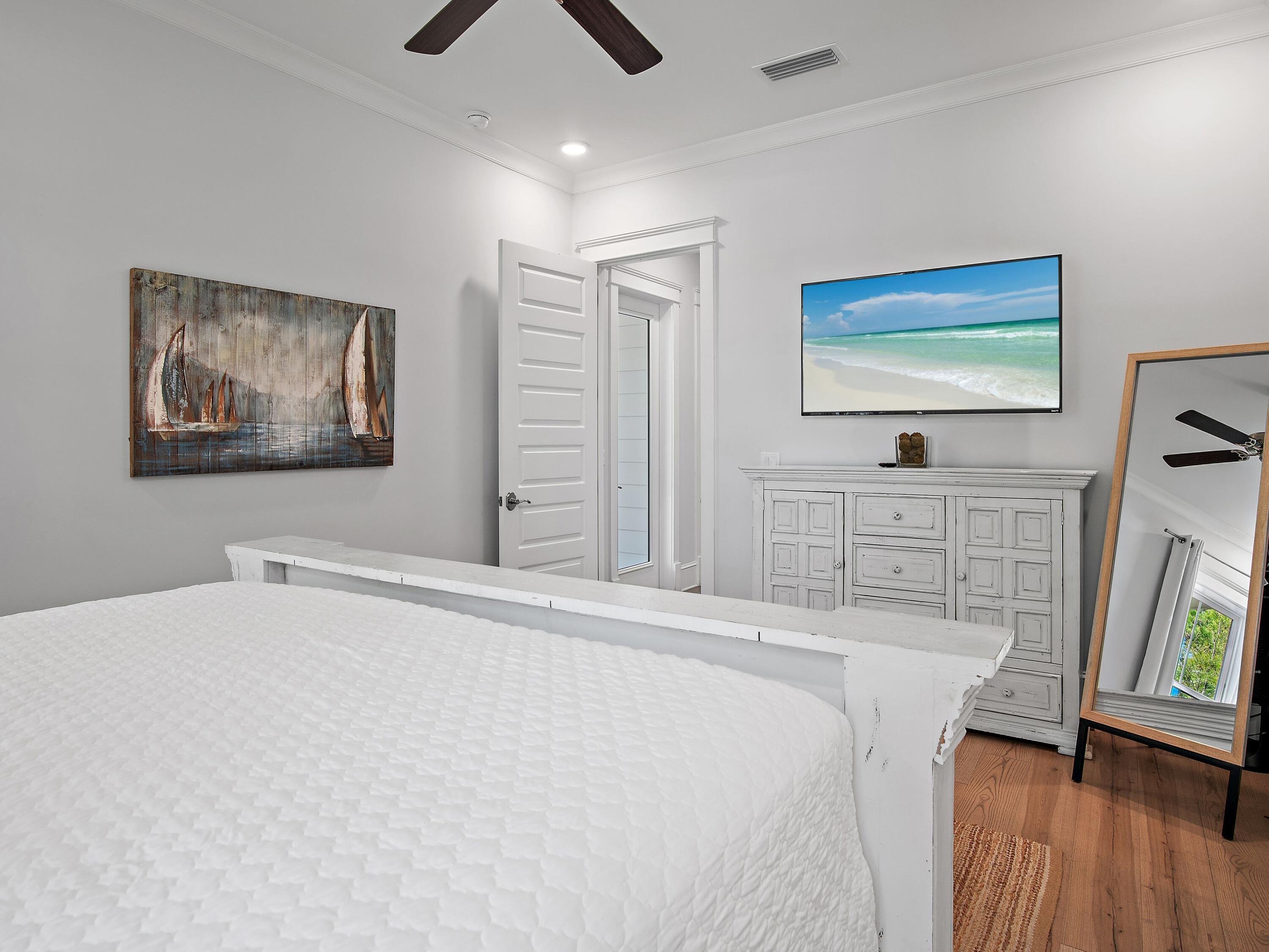 93 East Crabbing Hole Ln Inlet Beach Inlet Beach, FL 32461 - Photo 19 of 49 a bedroom with a bed and a flat screen tv