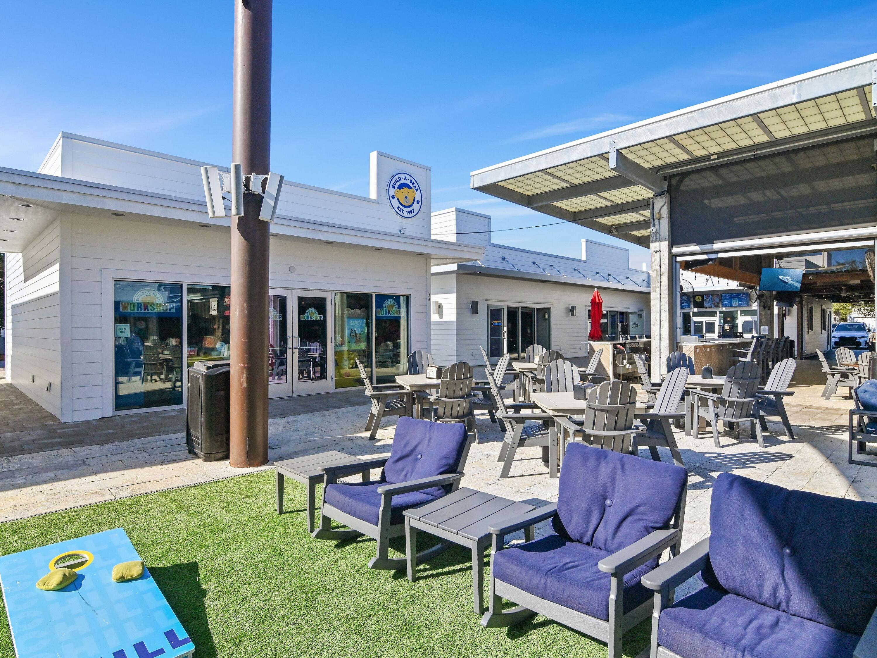 93 East Crabbing Hole Ln Inlet Beach Inlet Beach, FL 32461 - Photo 39 of 49 a outdoor space with lots of tables and chairs