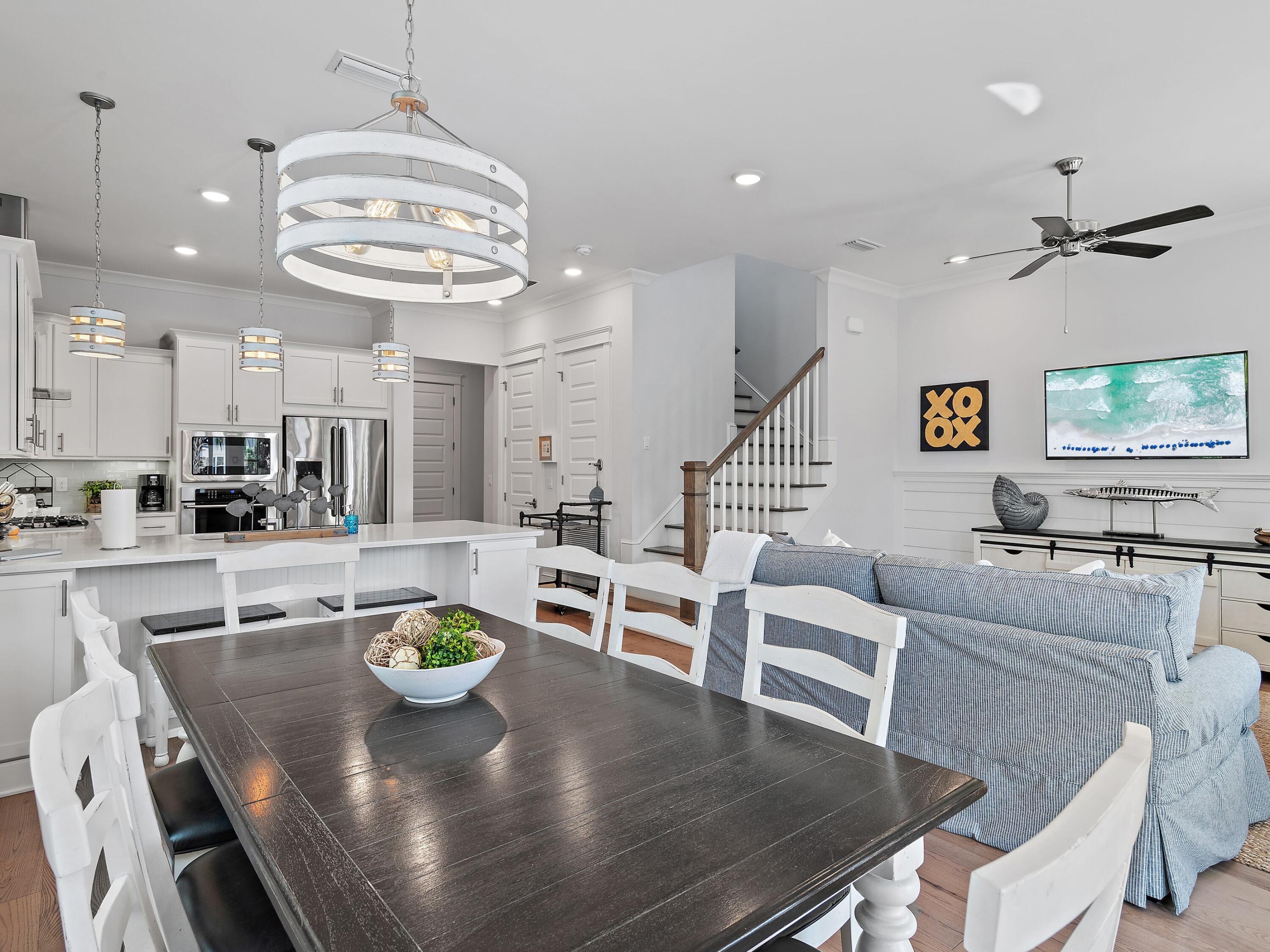 93 East Crabbing Hole Ln Inlet Beach Inlet Beach, FL 32461 - Photo 9 of 49 a view of a dining room with furniture a chandelier and wooden floor