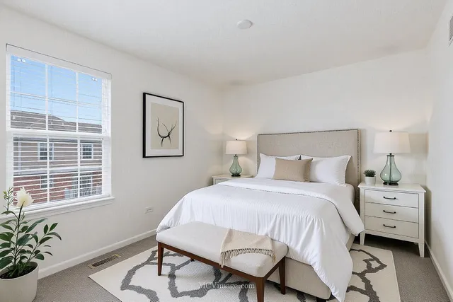 a bedroom with a bed a table and chair