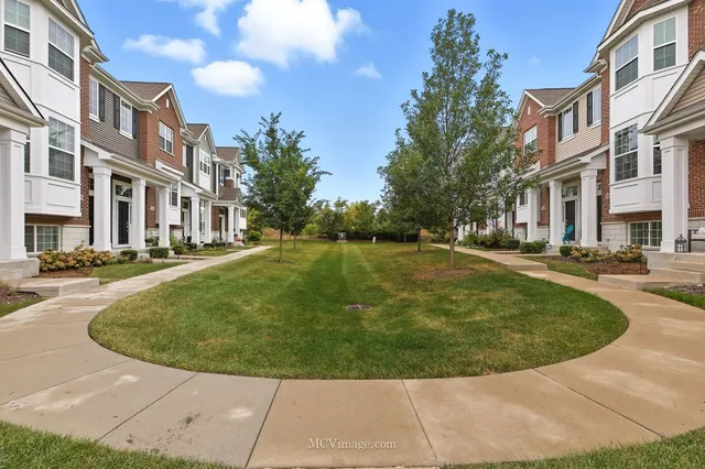a view of a community park with multi story residential apartment building