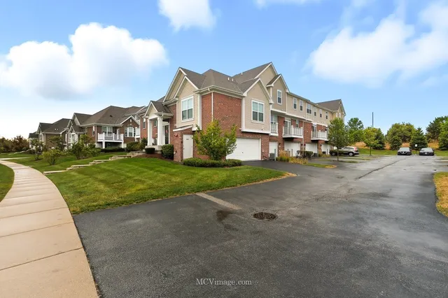 a view of multiple houses with a yard