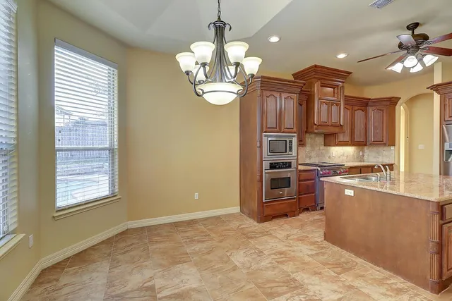 a kitchen with stainless steel appliances granite countertop a stove oven and a refrigerator